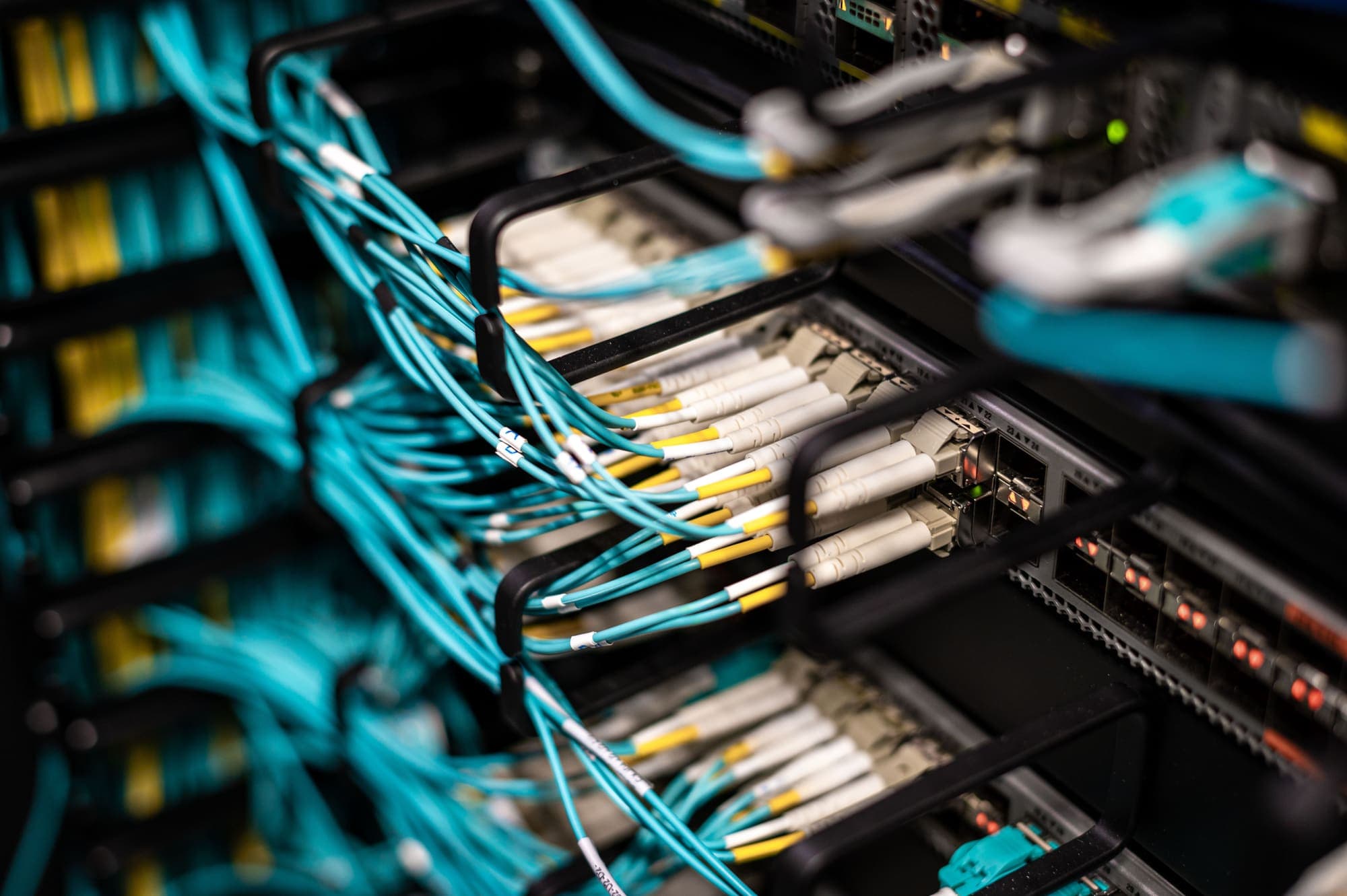 Fibre-optic cables patched into a network switch.